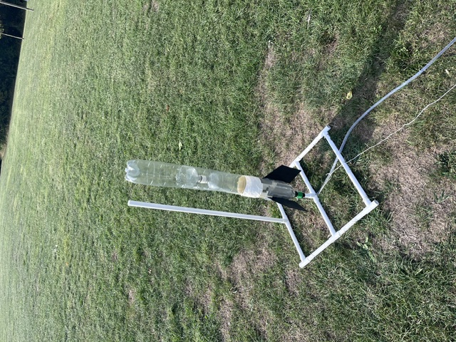 Three bottle water rocket on launch base